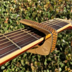 Thalia Premium Capo AAA Curly Hawaiian Koa Save The Bees Honeycomb (24K Gold) -Guitar Music Store da th cg202 04 capo premium aaa curly hawaiian save bees honeycomb gold 02